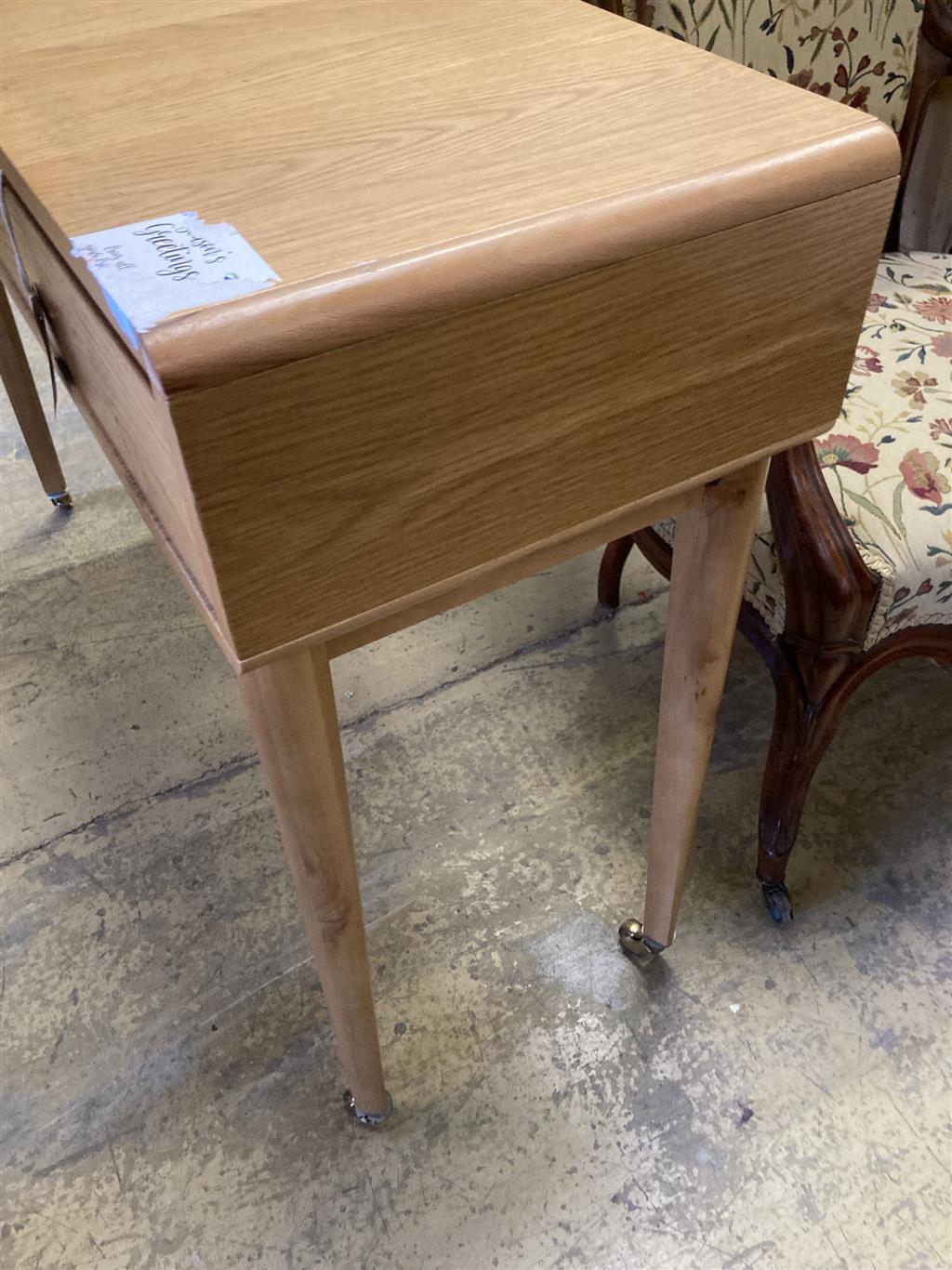 A contemporary oak two drawer side table, width 110cm, depth 35cm, height 79cm